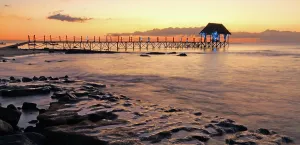 Retreat Prints: Sunset view from a pier in Mauritius with calm waters and distant clouds