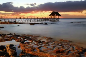 Retreat Prints: Sunset view from pier in Pointe Aux Piments, Mauritius as daylight fades into evening
