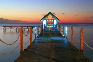 Rope Prints: Sunset view over a pier with soft colors and lights in the water at Pointe aux Piments in Mauritius