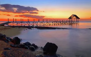 Mauritius Prints: Sunset view over a pier with water reflections and clouds in Pointe aux Piments, Mauritius