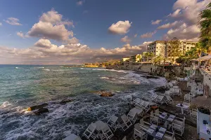 Crete Prints: Sunset view of taverna with a coastline and sea in Limenas Chersonisou