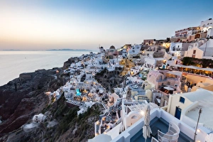 Caldera Prints: Sunset view over the whitewashed buildings and windmills of Oia, Santorini, Cyclades