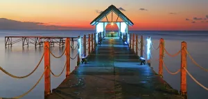 Gathering Prints: Sunset view from a wooden pier with lights over the water in Mauritius during evening hours