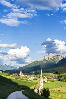 Sunshine over green pastures and village of Villabassa (Niederdorf) in summer