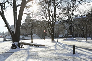 Sunshine in the snow-covered Berzelii Park, by the waterfront at Nybroviken, in Stockholm