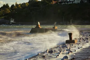 United Prints: Surf crashes against the breakwater at the mouth of the River Teign in Devon during sunset