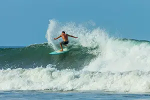 One Man Only Prints: Surfer on shortboard riding wave at popular Playa Guiones surf beach