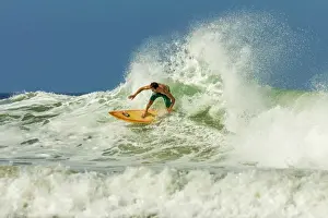 Surfer on shortboard riding wave at popular Playa Guiones surf beach, Nosara, Nicoya Peninsula, Guanacaste Province, Costa Rica, Central America