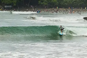 Water Sports Prints: Surfer on a wave at this popular point break surf spot and small resort