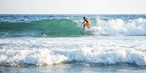 Pacific Coast Prints: Surfers surfing on a beach, Nosara, Guanacaste Province, Pacific Coast, Costa Rica