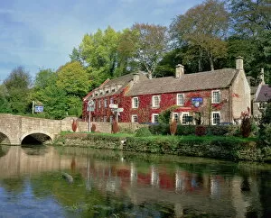 Gloucestershire Collection: The Swan Hotel reflected in the river at Bibury in the Cotswolds, Gloucestershire