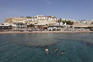 Red Sea Prints: Swimmers enjoy the clear Red Sea waters at Sharks Bay, Sharm el-Sheikh