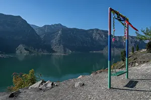 Calmness Prints: Swing over water in Dagestan with mountains surrounding the Awarskoje Koisu river in Russia