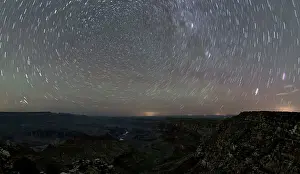 Watchtower Prints: The swirl of stars in the night sky over Grand Canyon South Rim viewed from Navajo Point with the historic Watchtower