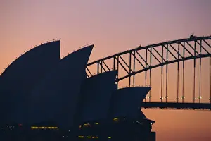 Sydney Opera House and Harbour Bridge silhouetted together at sunset, Sydney
