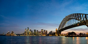 Sydney Prints: Sydneys iconic buildings lit up as dusk settles over the city, Sydney, New South Wales