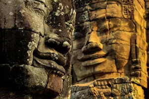 Ruined Gallery: T wo of 216 smiling sandstone faces at 12th century Bayon, King Jayavarman VII s