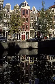 Netherland Prints: Tall traditional style houses reflected in the water of a canal