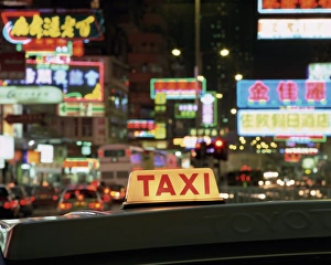 Illuminating Prints: Taxi sign and neon lights at night on Nathan Road, Kowloon, Hong Kong, China, Asia