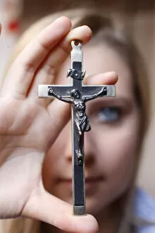 Teenage girl holding a crucifix, Saint Gervais, Haute Savoie, france, Europe