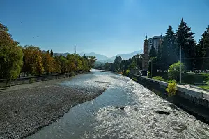 Downtown Prints: Terek river flows through Vladikavkaz with buildings and trees on the banks