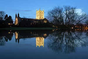 12th Century Gallery: Tewkesbury Abbey reflected in water at dusk, Tewkesbury, Gloucestershire, England