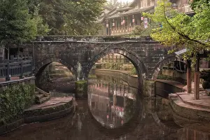 Stillness Prints: Three-arched stone bridge in Shangli Town reflects at dawn in Sichuan
