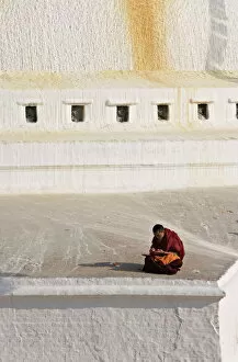 Images Dated 1st January 2000: Tibetan Buddhist monk reading scriptures at the Boudha