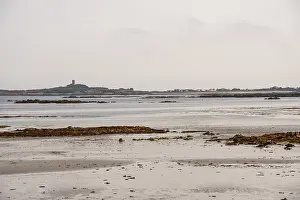 Flats Prints: Tidal flats in Rocquaine Bay reveal Guernsey's coastline and distant landmarks at low tide