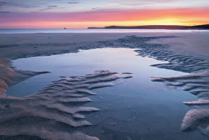 Tidal Pool Prints: Tidal pools on a deserted sandy beach at sunrise