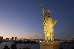 Illuminating Prints: Tokyo Tower and the replica Statue of Liberty illuminated at dusk