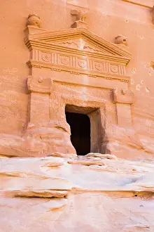 Arabia Prints: Tomb carved into sandstone rock of Jabal Banat (Qasr Al-Bint) area in site of Hegra (Madain Salih)