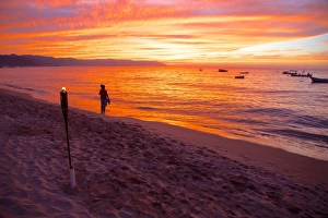 Torch Prints: Torch and couple on the beach in Downtown at sunset