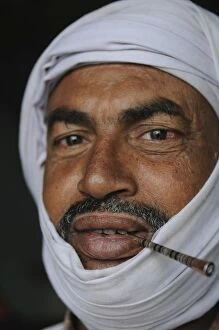 Images Dated 8th February 2008: Touareg smoking a traditional cigarette, Nouadhibou, Mauritania, West Africa, Africa
