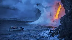 Lava Prints: A tour boat observes lava pouring into the sea from 60 feet above as steam plumes billow
