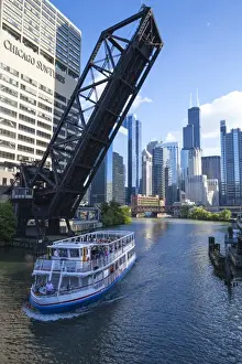 Interlandmark Prints: Tour boat passing under a raised disused railway bridge on the Chicago River