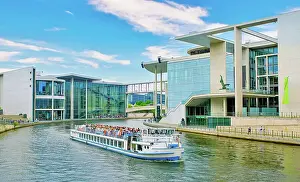 Cultural Landmark Prints: A tour boat on the River Spree passing the Library of the German Parliament on the right near the Reichstag building
