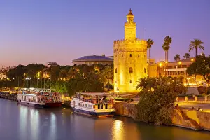 Light Beam Prints: Tour boats moored on the Guadalquivir river near the Torre del Oro at sunset, Seville