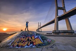 Tagus River Prints: A tourist admires the majestic Vasco da Gama Bridge over the River Tagus