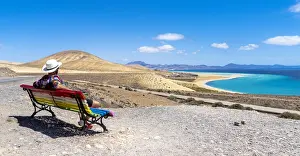 One Mid Adult Man Only Prints: Tourist admiring the crystal ocean from a bench at Mirador Del Salmo viewpoint