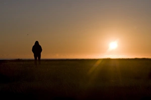 West Fjords Prints: Tourist admiring the midnightsun, Breidavik, Westfj?rds, Iceland, Polar Regions