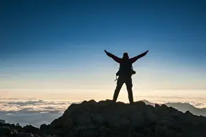 Mature Men Prints: Tourist in backlight waiting for sunset on top of Haleakala National Park