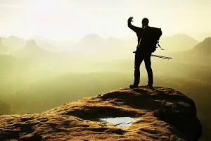 Young Animals Prints: Tourist with backpack and poles in hand shadowing eyes