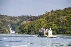 Murchison Falls Prints: Tourist boat cruising the Nile in front of the Murchison Falls (Kabarega Falls) on the Nile