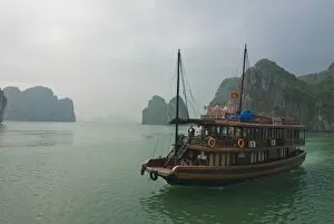 Tourist boat in a traditional style cruising the Halong Bay, Vietnam, Indochina