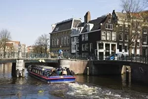 Tourist canal boat on the Leidsegracht canal, Amsterdam, Netherlands, Europe