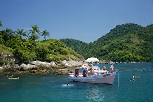 Parati Prints: Tourist on a chartered fishing boat cruising between the different beaches and islands around Parati