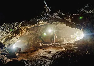 Weekend Activities Prints: Tourist exploring the Ana Kakenga Cave, Rapa Nui National Park, UNESCO World Heritage Site