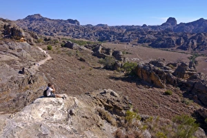 Images Dated 22nd August 2007: Tourist looking over the rock formations of the Isalo National Park, Madagascar, Africa