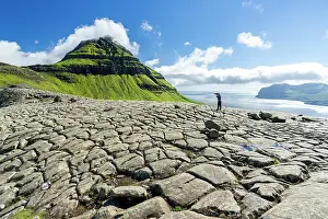 Photographer Prints: One tourist photographing Skaelingsfjall mountain standing on cracked soil in summer